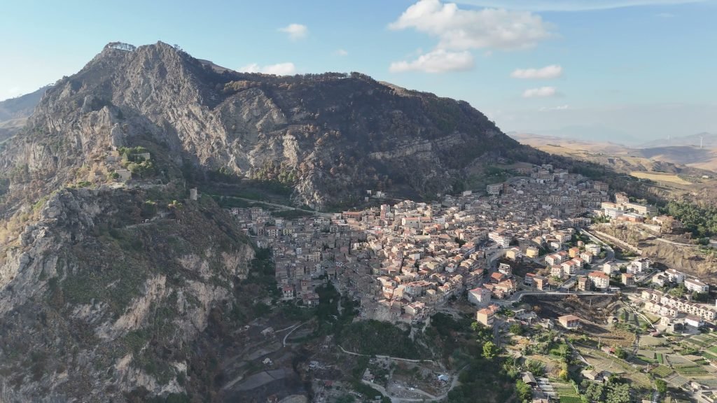 Castronovo di Sicilia nestled below the limestone crag that rises above the town